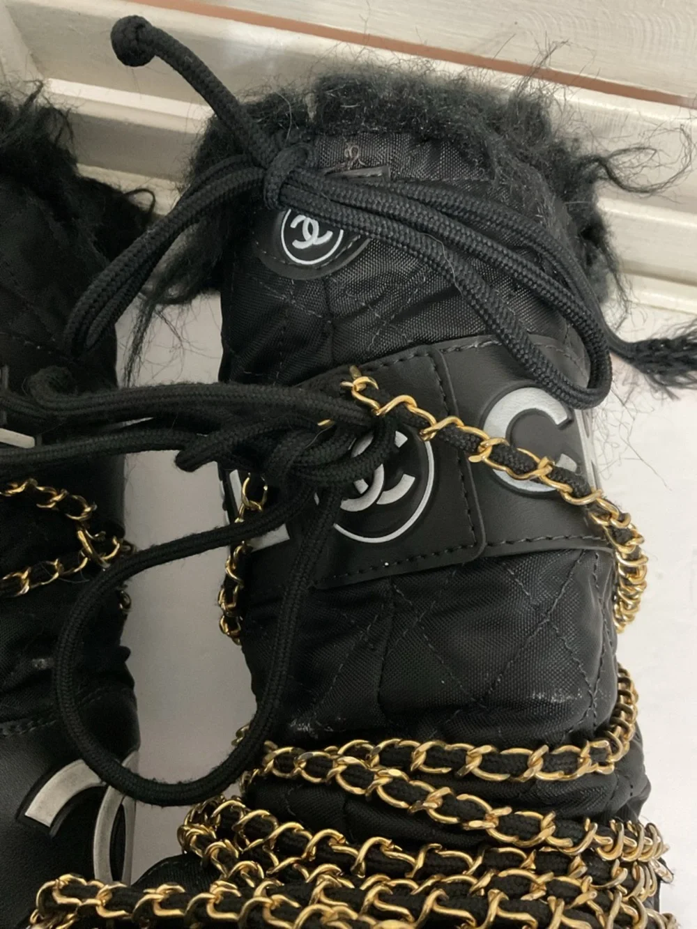 CHANEL Black and Gold Quilted Winter Lace-Up Boots